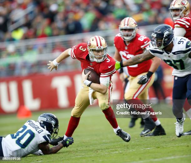 Beathard of the San Francisco 49ers scrambles during the game against the Seattle Seahawks at Levi's Stadium on November 26, 2017 in Santa Clara,...