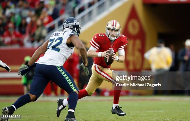 Beathard of the San Francisco 49ers looks for an open receiver during the game against the Seattle Seahawks at Levi's Stadium on November 26, 2017 in...