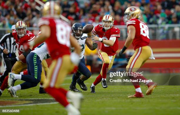 Beathard of the San Francisco 49ers looks for an open receiver during the game against the Seattle Seahawks at Levi's Stadium on November 26, 2017 in...