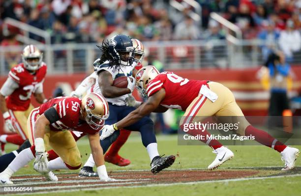 Ronald Blair III of the San Francisco 49ers tackles Eddie Lacy of the Seattle Seahawks during the game at Levi's Stadium on November 26, 2017 in...