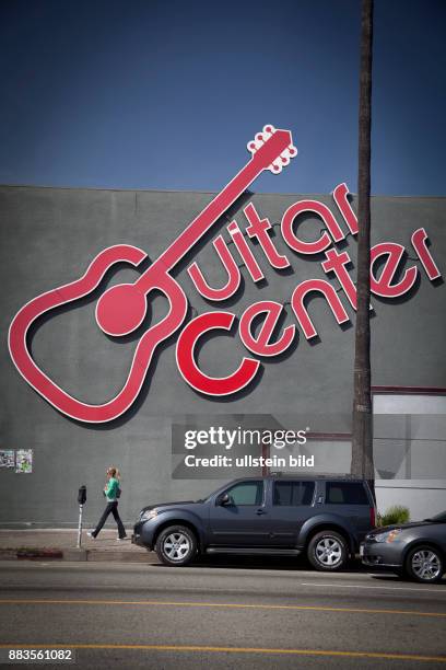 Giant guitar on the wall advertises for the Guitar Center in Hollywood on Sunset Boulevard.