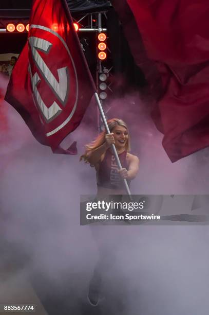 An Aggie dance team member carries the SEC flag from the tunnel before the basketball game between the University of Texas - Rio Grande Vaqueros and...