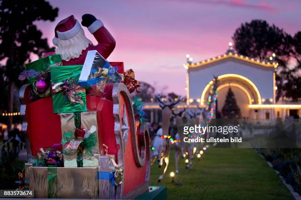 Santa Claus is facing the Spreckels Organ Pavilion at the pre-Xmas December Nights at Balboa Park.
