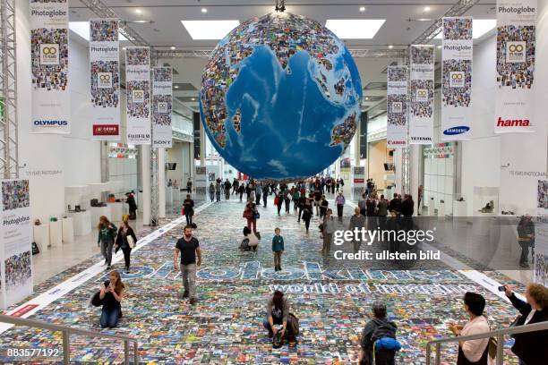 Photographs from all over the world under a huge globe at the trade fair Photokina in Cologne.