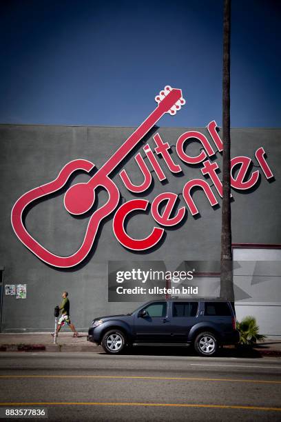 Giant guitar on the wall advertises for the Guitar Center in Hollywood on Sunset Boulevard.