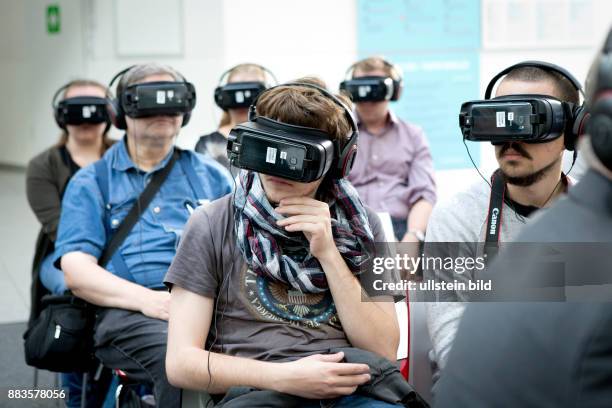 Virtual and augmented reality at the Photokina in Cologne: People wearing virtual reality head-mounted displays.