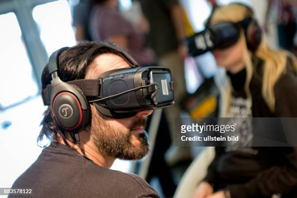 Virtual and augmented reality at the Photokina in Cologne: Man with a virtual reality Head-Mounted Display.