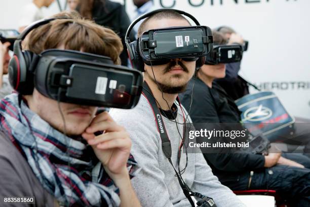 Virtual and augmented reality at the Photokina in Cologne: People wearing virtual reality head-mounted displays.