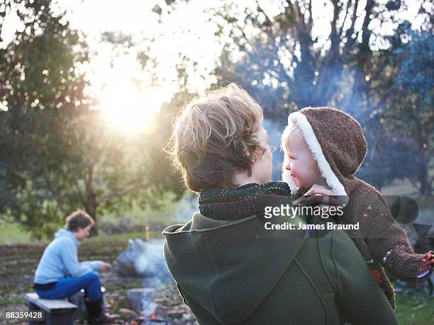 mother with child in arms camping - camping australia stock-fotos und bilder