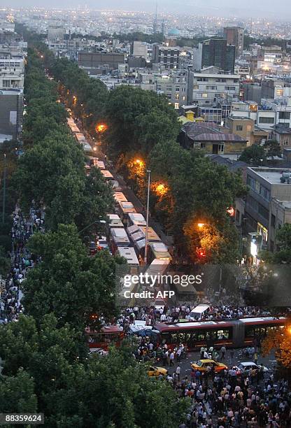Valiasr Street, the longest street in Iran, linking the south with the north of Tehran, bocked by public transport vehicles as Iranians take part in...