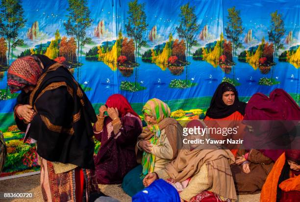 Kashmiri Muslim women devotees pray, at Hazratbal shrine on the Eid-e-Milad , or the birth anniversary of Prophet Mohammad on December 1, 2017 in...