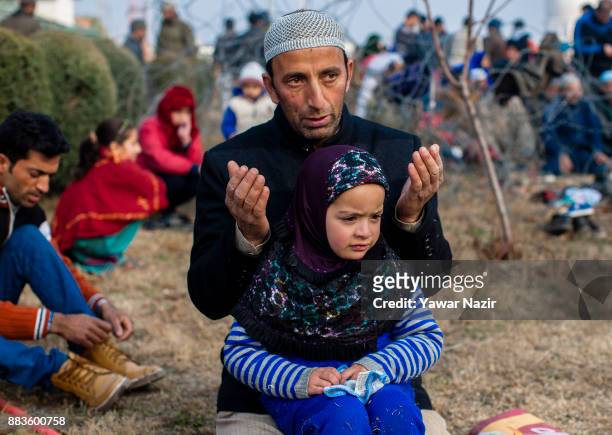 Kashmiri Muslim devotee pray, at Hazratbal shrine on the Eid-e-Milad , or the birth anniversary of Prophet Mohammad on December 1, 2017 in Srinagar,...