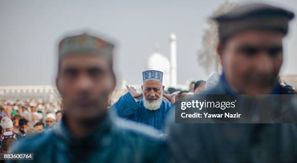 Kashmiri Muslim devotees pray, at Hazratbal shrine on the Eid-e-Milad , or the birth anniversary of Prophet Mohammad on December 1, 2017 in Srinagar,...