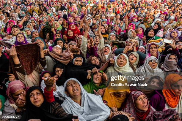 Kashmiri Muslim women devotees look towards a cleric displaying the holy relic believed to be the whisker from the beard of the Prophet Mohammed, at...