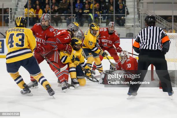 Ohio State Buckeyes goalie Sean Romeo blocks a shot by Michigan Wolverines forward Cooper Marody during a regular season Big 10 Conference hockey...