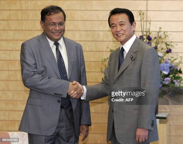 Bangladesh Foreign Affairs Minister Hasan Mahmud shakes hand with Japanese Prime Minister Taro Aso during their meeting at the latter's official...