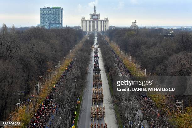 Members of Romanian army forces march during a military parade to celebrate the National Day of Romania in Bucharest on December 1, 2017.