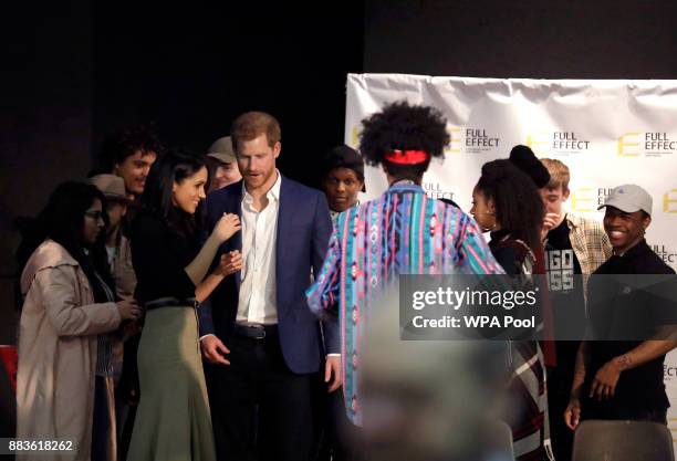 Prince Harry and his fiancee US actress Meghan Markle talk to the cast after a hip hop opera performed by young people involved in the Full Effect...