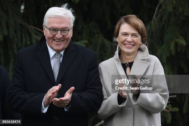 German President Frank-Walter Steinmeier and First Lady Elke Buendenbender listen as children sing Christmas songs before inaugurating the Christmas...