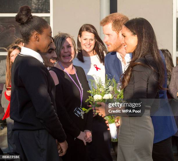 Prince Harry and his fiancee US actress Meghan Markle meet pupils during their visit to Nottingham Academy on December 1, 2017 in Nottingham,...