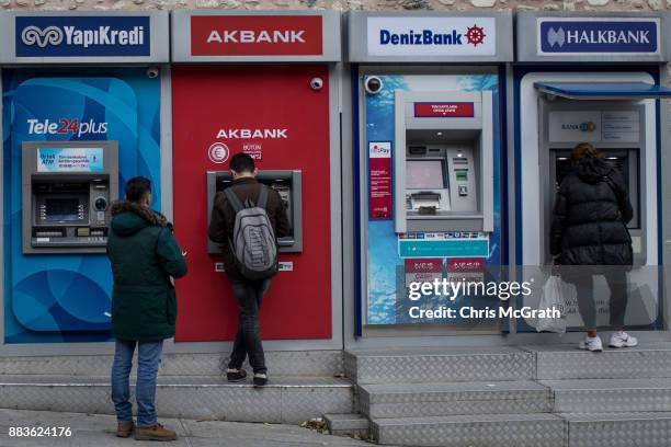 People use Turkish bank ATM machines on December 1, 2017 in Istanbul, Turkey. The trial of Mr. Reza Zarrab, an Iranian-Turk who ran a foreign...