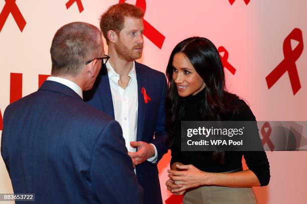 Prince Harry and his fiancee US actress Meghan Markle meet with a representative of a charity working around HIV/AIDS at the Terrence Higgins Trust...