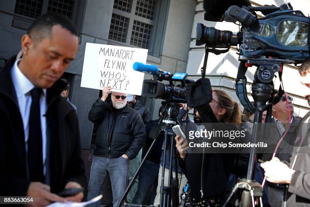 Handful of demonstrators held signs as they joined journalists outside the Prettyman Federal Courthouse where Michael Flynn, former national security...