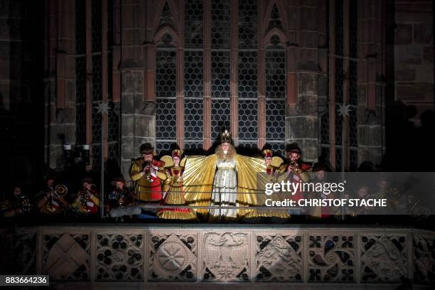 Young resident Rebecca Ammon, dressed as the "Nuremberg Christkind" , stands at the balcony of the Frauenkirche Church during the opening of the...