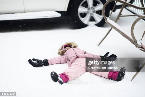 making a snow angel - angel funny stock pictures, royalty-free photos & images