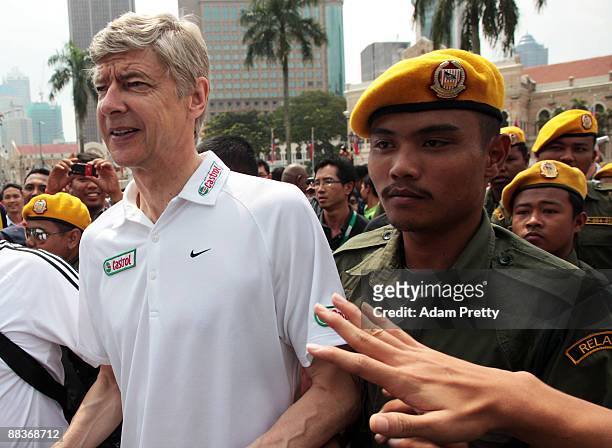 Arsene Wenger meets the fans before taking the Malaysian youth team through the Castrol Challenge at the Dataran Merdeka Square during his tour of...