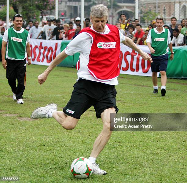 Arsene Wenger meets the fans before taking the Malaysian youth team through the Castrol Challenge at the Dataran Merdeka Square during his tour of...