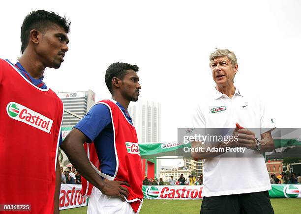 Arsene Wenger taking the Malaysian youth team through the Castrol Challenge at the Dataran Merdeka Square during his tour of Asia with FIFA World Cup...