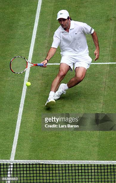 Fabrice Santoro of France plays a forehand during his first round match against Jo Wilfried Tsonga of France on day 2 of the Gerry Weber Open at the...