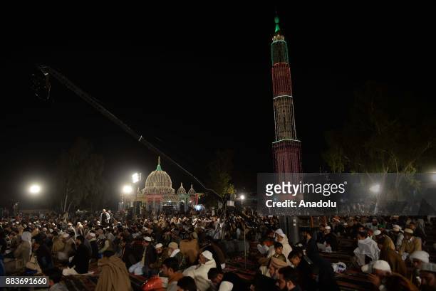 Pakistani Muslim devotees attend a religious ceremony during the celebrations for Mawlid al-Nabi, the birth anniversary of Muslims' beloved Prophet...