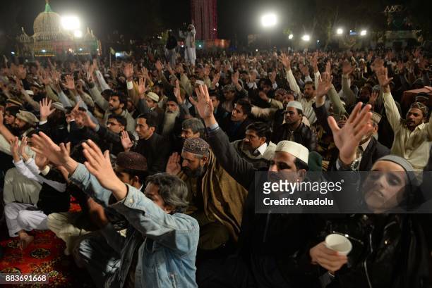 Pakistani Muslim devotees attend a religious ceremony during the celebrations for Mawlid al-Nabi, the birth anniversary of Muslims' beloved Prophet...