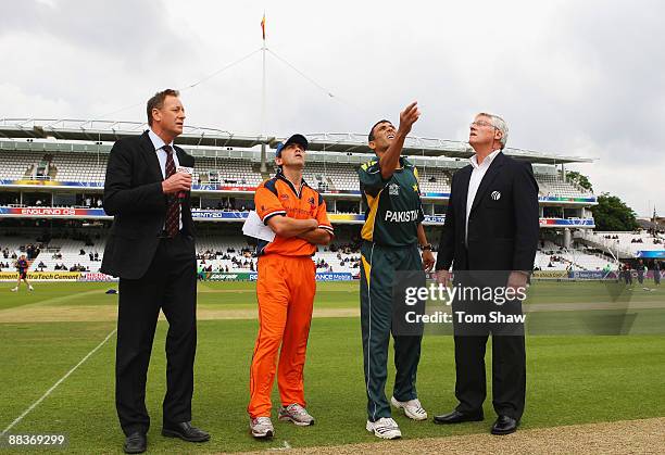 Younis Khan of Pakistan tosses the coin watched by Jeroen Smits of Netherlands, commentator Jeremy Coney and match referee Alan Hurst ahead of the...