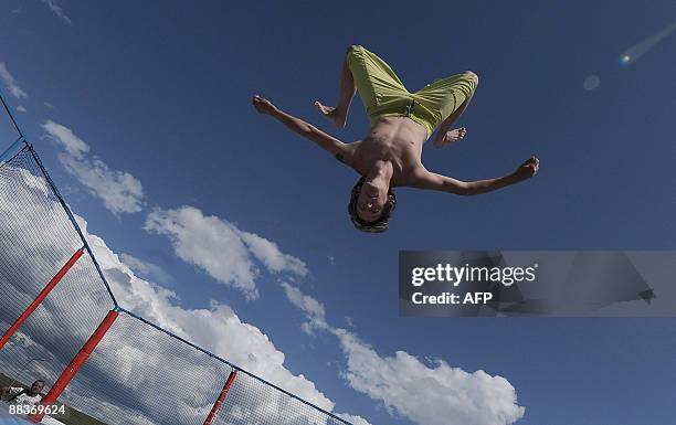 Boy flies in the air as he jumps on a trampoline at water park 'Aquapark Tatralandia' in central Slovak city of Liptovsky Mikulas on June 8, 2009....