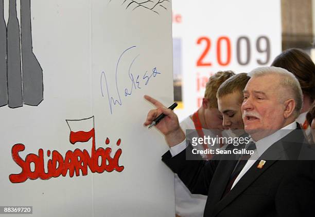 Lech Walesa, former Polish President and leader of the Solidarity labour movement that toppled the communist regime in Poalnd in 1989, points to his...