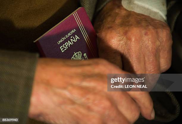 Lou Kenton holds his Spanish passport at the Spanish embassy in west London following a ceremony to thank British and Irish veterans of the Spanish...