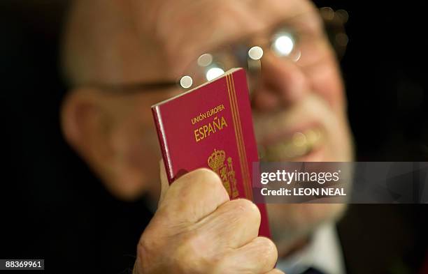 Patrick "Paddy" Cochrane holds his Spanish passport at the Spanish embassy in west London following a ceremony to thank British and Irish veterans of...