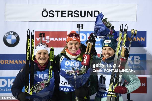 Second placed France's Justine Braisaz, winner Germany's Denise Herrmann and third placed Ukraine's Yuliia Dzhima celebrate after the women 7,5 km...