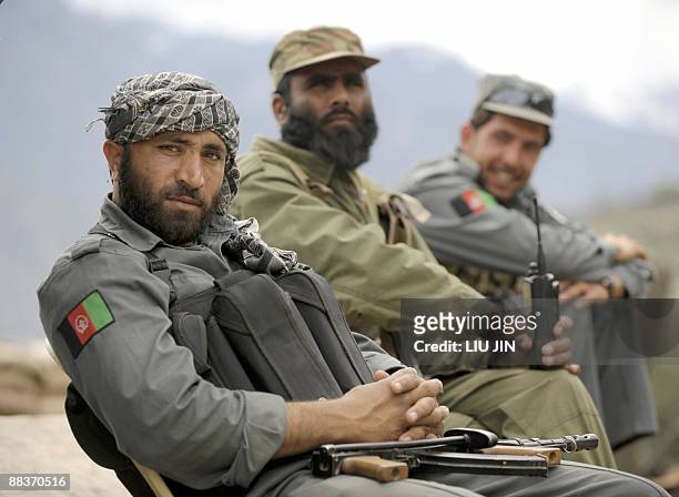 Afghan policemen are pictured at a police station in Naray, in Afghanistan's eastern Kunar province on April 13, 2009. US President Barack Obama,...
