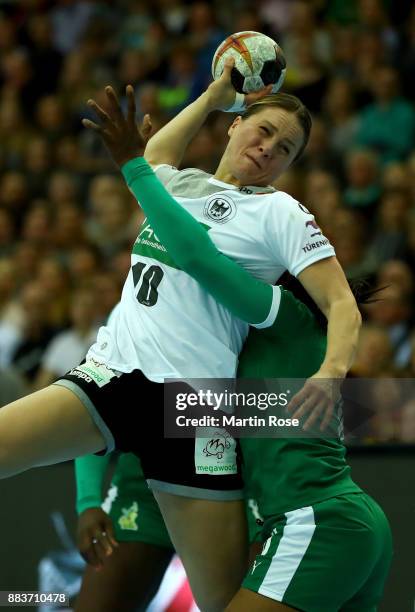 Anna Loerper of Germany challenges of Yvette Yuoh of Cameroon during the IHF Women's Handball World Championship group D match between Germany and...