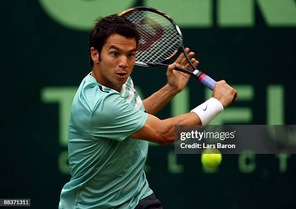 Bjoern Phau of Germany plays a backhand during his first round match against Philipp Kohlschreiber of Germany on day 2 of the Gerry Weber Open at the...