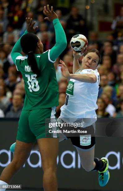 Anna Loerper of Germany challenges Aubiege Njampou Nono of Cameroon during the IHF Women's Handball World Championship group D match between Germany...