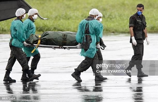 Brazilian Air Force personnel unload from a chopper the corpse of one of the passengers of the ill-fated Air France flight 0447 lost on midflight...