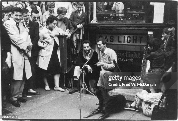 Journalist Yaakov Kohn and writer & cafe owner John Mitchell stand on the steps that lead down to Mitchell's Gaslight Cafe , a coffee house and...