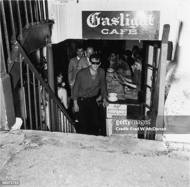 View down the step to the entrance of the Gaslight Cafe , a coffee house and nightclub in Greenwich Village, New York, New York, late 1950s. One of...