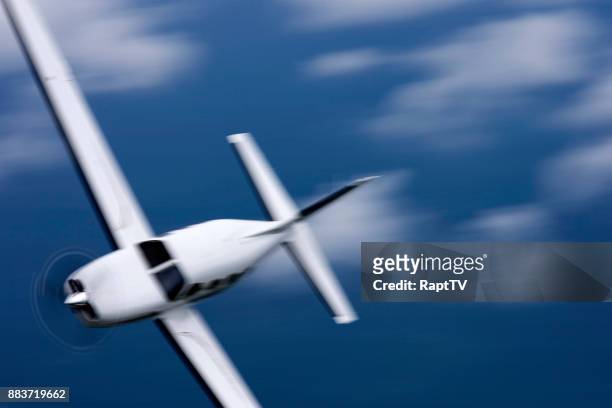 motion blur of airplane in super fast banked turn air to air. - fast motion stock pictures, royalty-free photos & images