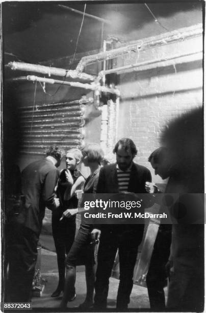 American fashion model and actress Edie Sedgwick talks with an unidentified man and woman at a party for American poet John Ashbery in pop artist...